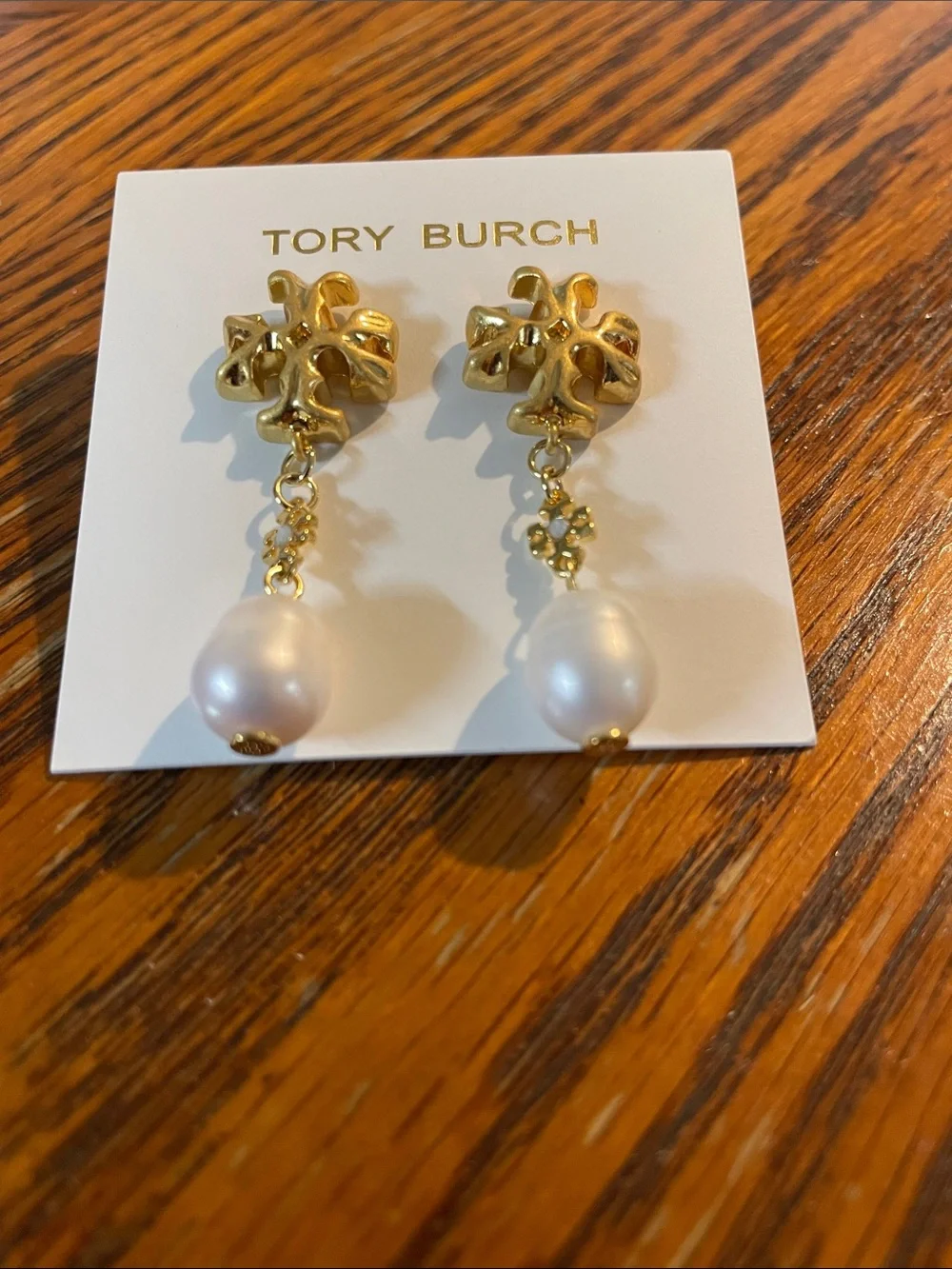 Brand new pearl-drop earrings by Tory Burch.